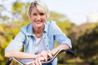 middle age woman on bike after successful weight loss diet