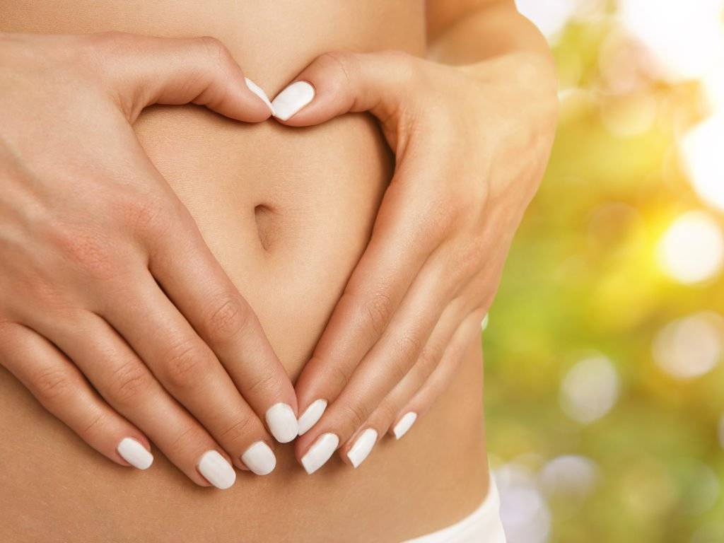 woman holding stomach with love thanks to HcG diet plan